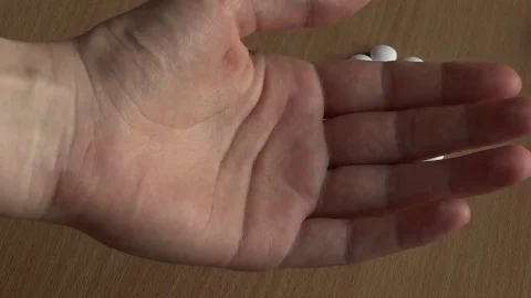 Tablet in hand. Heart made out of pills. Video stock 75207064