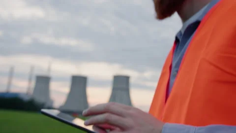 Tablet in the hands of an engineer against the background of a power plant Stock Footage 201669348