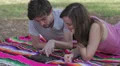 Tablet - Happy young couple with tablet computer in the park - watching photo HD Footage