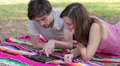 Tablet - Happy young couple with tablet computer in the park - watching photo HD Footage