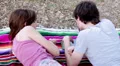 Tablet - Happy young couple with tablet computer in the park HD Footage