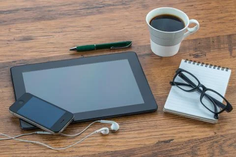 Tablet, headphone, notebook and smart phone with coffee Stockfoto's