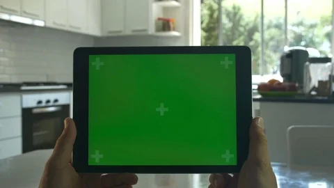 Tablet held by hands. Green screen Chroma Key. Close up. Tracking motion.  4K Stock Footage 82151052