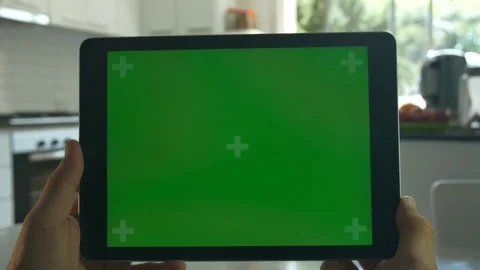 Tablet held by hands. Green screen Chroma Key. Close up. Tracking motion.  4K Stock Footage 82151924