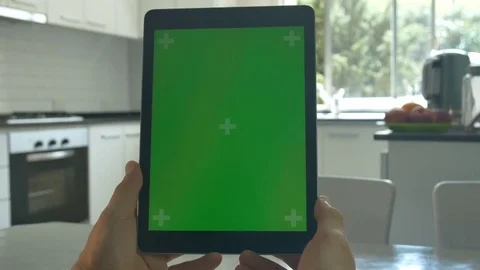 Tablet held by hands. Green screen Chroma Key. Close up. Tracking motion 4K Stock Footage 82153101