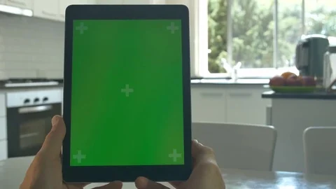 Tablet held by hands. Green screen Chroma Key. Close up. Tracking motion.  4K Stock Footage 82153957