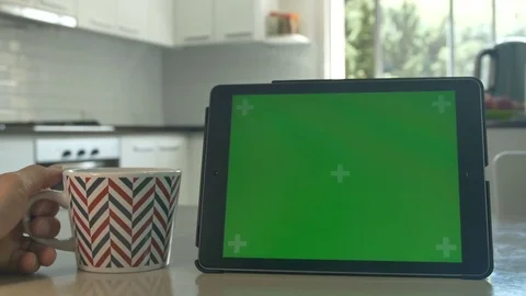 Tablet held by hands Green screen Chroma Key Close up Tracking motion Tee cup 4K Stock Footage 82168738