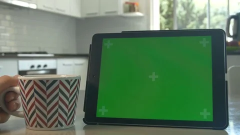 Tablet held by hands Green screen Chroma Key Close up Tracking motion Tee cup 4K Stock Footage 82170601