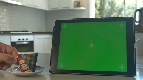 Tablet held by hands. Green screen Chroma Key. Close up. Tracking motion. 4K Stock Footage 82356108