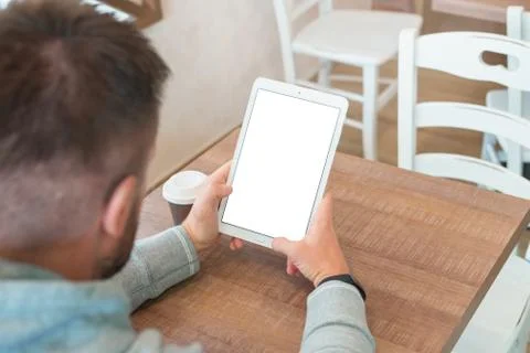 Tablet with isolated screen in man hand. Blank screen for mockup. Stock Photos