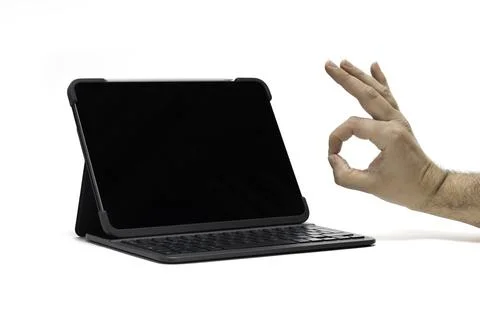 A tablet with keyboard device on a white background with hand approval Stock Photos