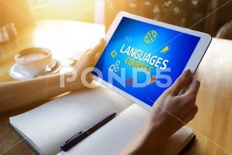 Tablet with languages courses text and icons on screen. English learning online Stock Photos