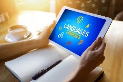 Tablet with languages courses text and icons on screen. English learning online Stock Photos
