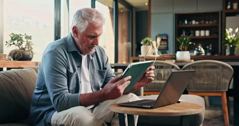 Tablet, laptop and fail with old man on sofa for mortgage debt, retirement funds Stock Footage 326644565