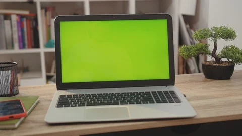 On tablet laptop computer with green scr... | Stock Video | Pond5