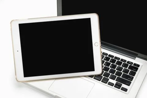 Tablet on Laptop computer on white Stock Photos