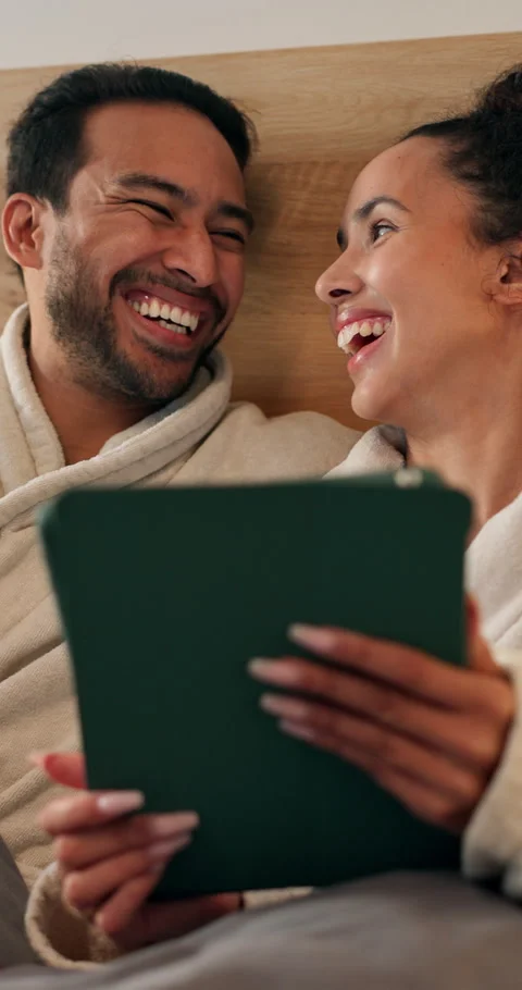 Tablet, laugh and couple on bed in house with funny meme on social media Stock Footage 340893207