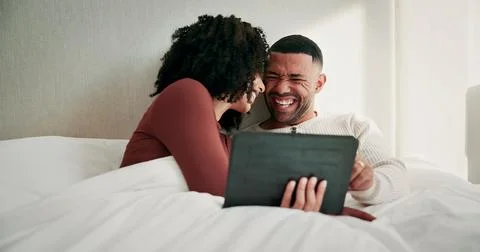 Tablet, laugh and couple on bed in home with watching comedy movie, series .. Stock Photos