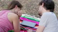 tablet - loving couple having fun watching pictures on a tablet at the park HD Footage