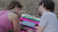 tablet - loving couple having fun watching pictures on a tablet at the park HD Footage