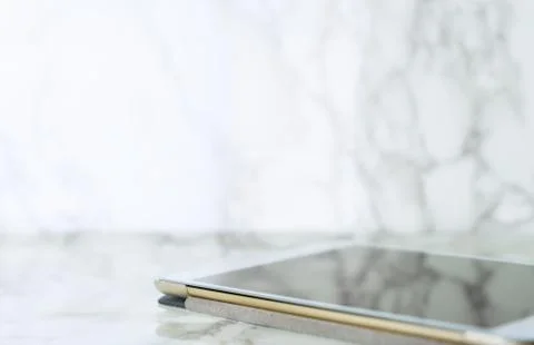 Tablet on luxury marble table with copy space Stock Photos