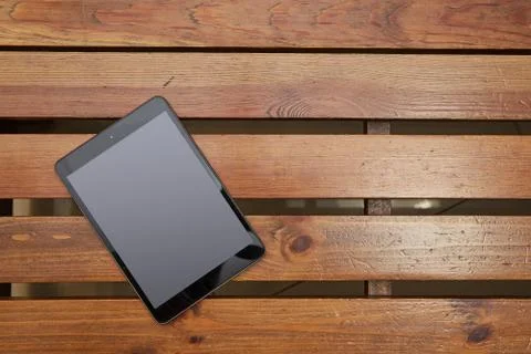 The tablet lying on a wooden table Stock Photos