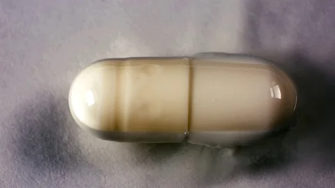 The tablet melts in the capsule in water Stock Footage 70641007