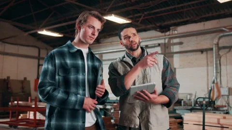 Tablet, men and talk in carpentry warehouse for online stock review, project Stock Footage 338045894