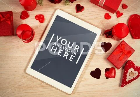 Tablet in the middle of hearts and gifts PSD Template