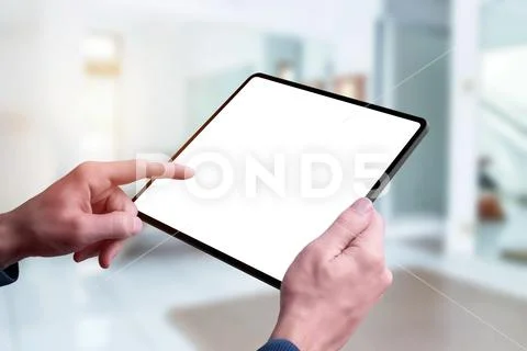 Tablet mockup in hands. Left hand touch screen. Close-up PSD Template
