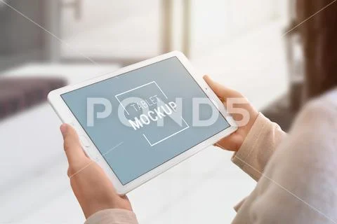 Tablet mockup in woman hands. Smart object display for app presentation PSD Template