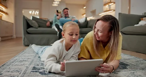 Tablet, mom and child on floor for learning, reading ebook and relax with Stock Footage 337925021