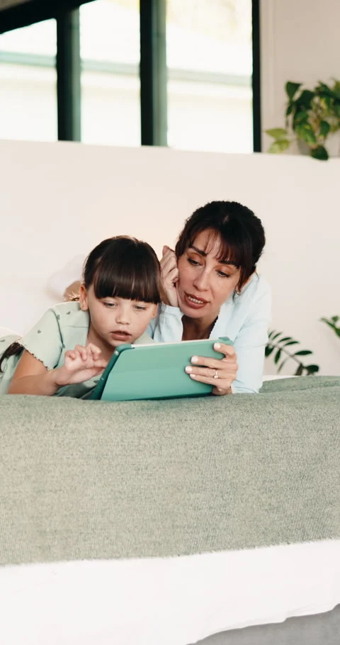 Tablet, mom and kid in bedroom for learning, relax together or storytelling with Stock Footage 335830879