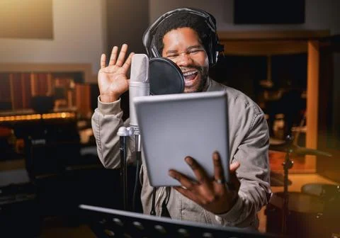 Tablet, music studio and man singing lyrics, song production or musician Stock Photos