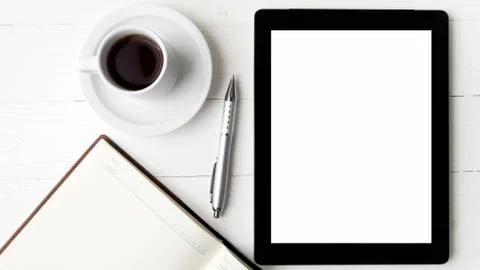 Tablet with notebook and coffee cup Stock Photos