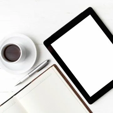 Tablet with notebook and coffee cup Stock Photos