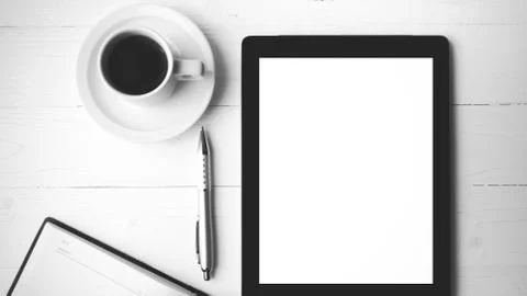 Tablet with notebook and coffee cup black and white color style Stock Photos