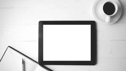 Tablet with notebook and coffee cup black and white color style Stock Photos