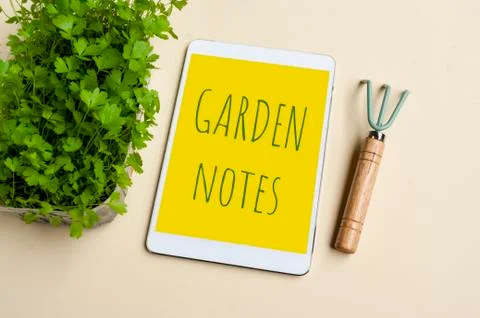 Tablet notebook for making gardening notes and plans, green fresh sprouts and Foto stock