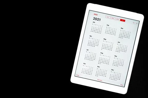 Tablet with open calendar for 2021 year isolated on a black background. space Foto stock