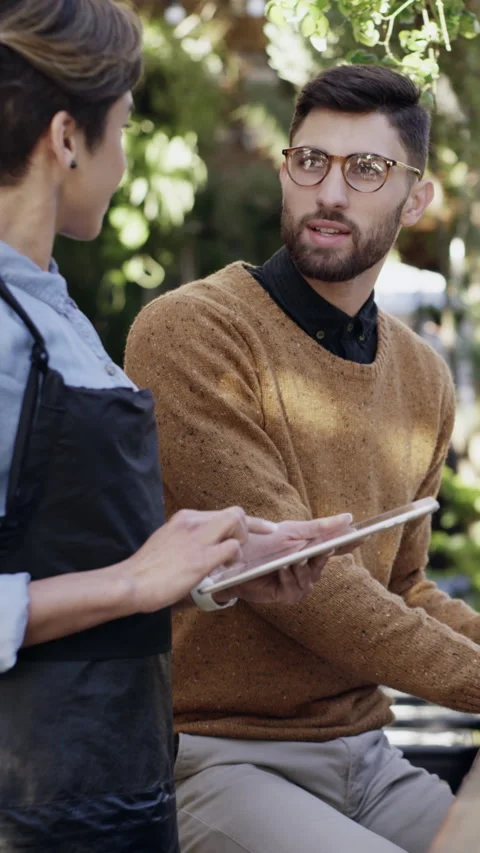 Tablet, order and waitress with man at restaurant with hospitality, customer Stock Footage 329778410