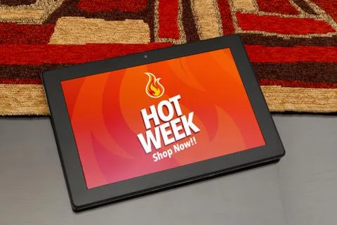 Tablet over the table with Hot Week advertising on the screen. Marketing, e-c Stock Photos