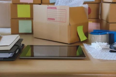 Tablet, packing accessories at workplace of startup small business owner. car Stock Photos