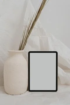 Tablet pad screen with empty free copy space for mock up, clay flowerpot with Stock Photos