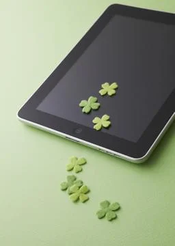 Tablet PC and clovers Stock Photos