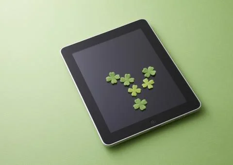 Tablet PC and clovers Stock Photos