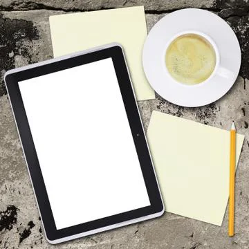Tablet pc and coffee cup on old concrete surface Stock Illustration