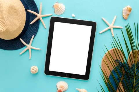 Tablet pc with blank screen mockup. Summer beach concept. Starfishes with palm Stock Photos