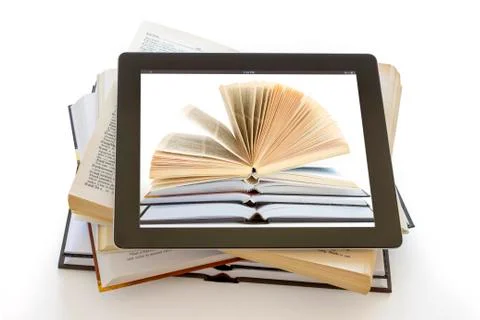 Tablet pc with books background on opened books Фото