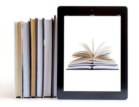 Tablet pc with books background 库存照片